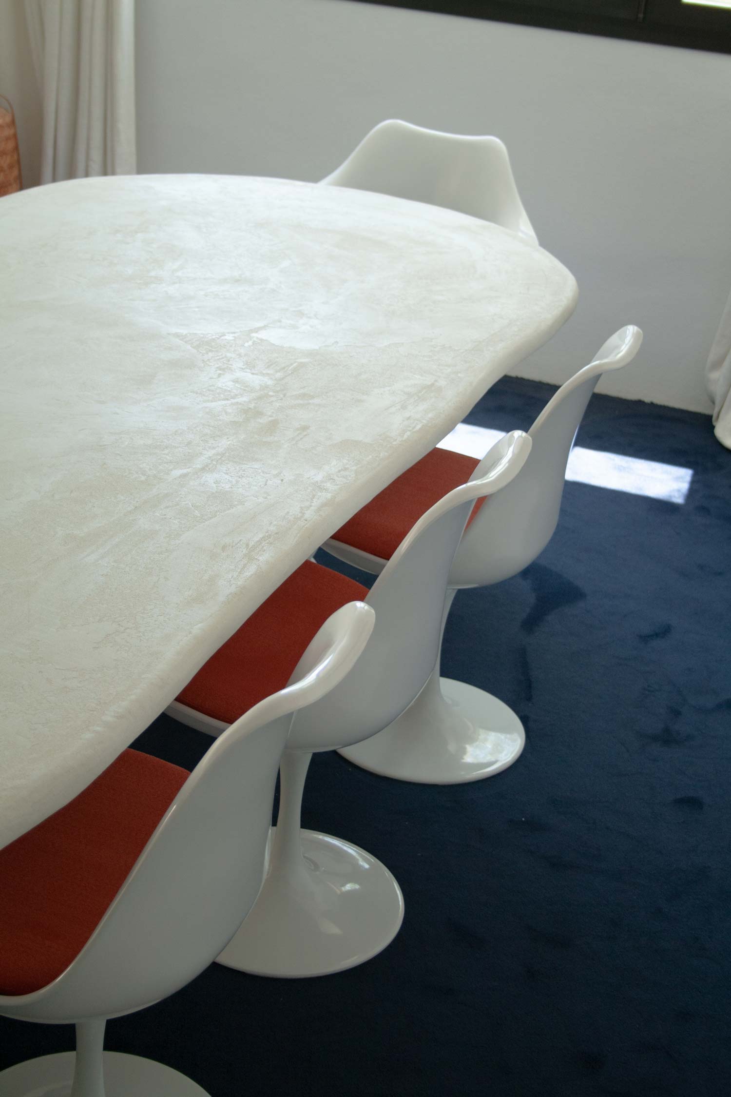 Custom made dining table, Ibiza, called “Artefact dining table“ with two artefact, totem like bases and a long oval playful imperfect shape tabletop. Materials are hempcrete, limestone, wood, mortex. design by studio jannis schaefer