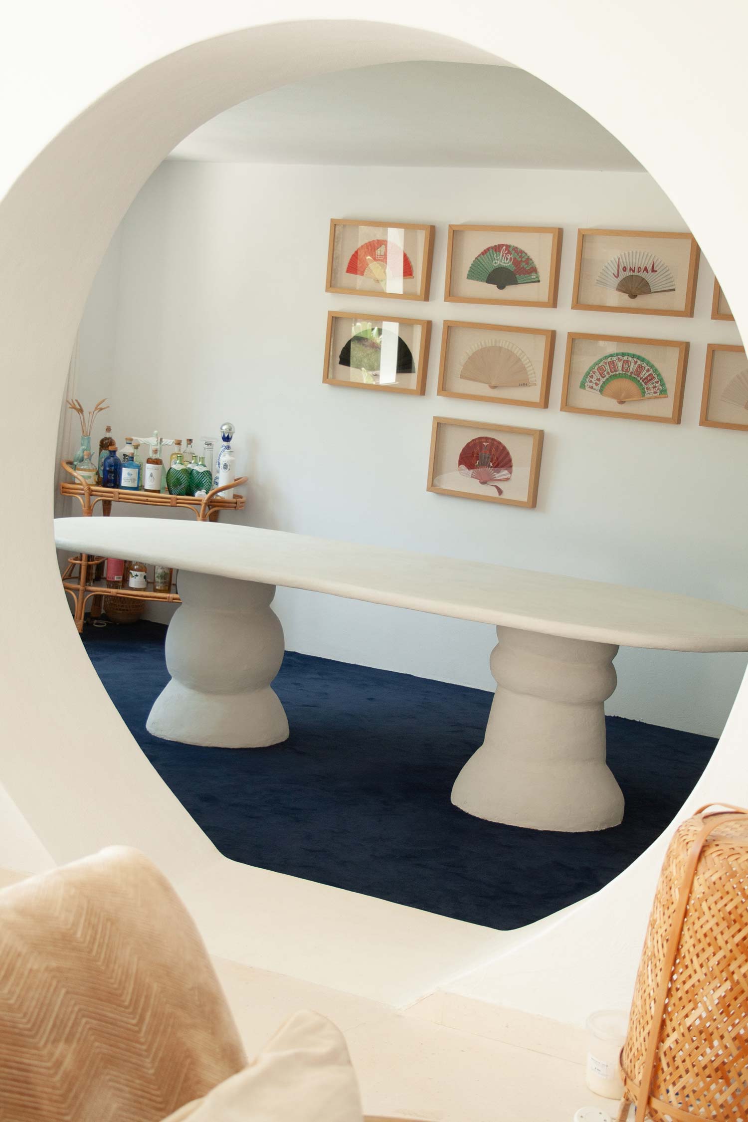 Custom made dining table, Ibiza, called “Artefact dining table“ with two artefact, totem like bases and a long oval playful imperfect shape tabletop. Materials are hempcrete, limestone, wood, mortex. design by studio jannis schaefer