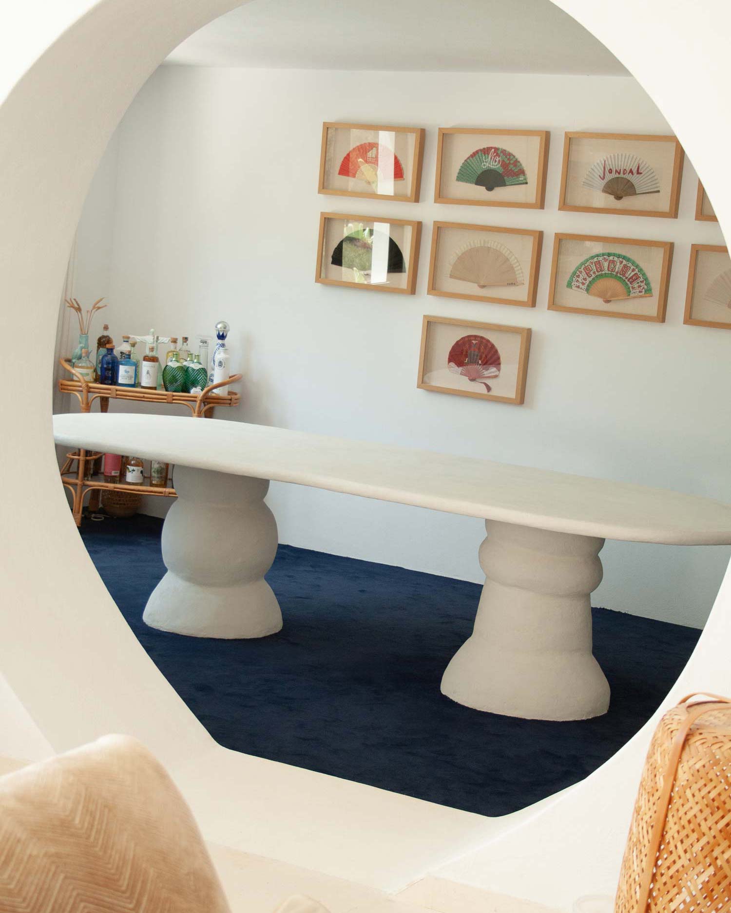 Custom made dining table, Ibiza, called “Artefact dining table“ with two artefact, totem like bases and a long oval playful imperfect shape tabletop. Materials are hempcrete, limestone, wood, mortex. design by studio jannis schaefer