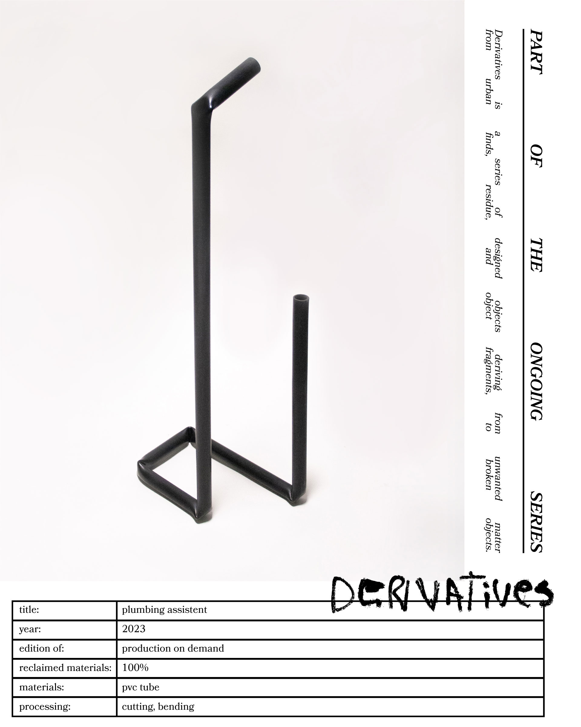 A toilet paper holder created by Jannis Schäfer Studio, made from a reclaimed PVC tube. The design features a black, L-shaped frame with one vertical rod holding a roll of toilet paper at the top and a second vertical rod holding multiple spare rolls. This object is part of a series of upcycled, recycled, and transformed designs.