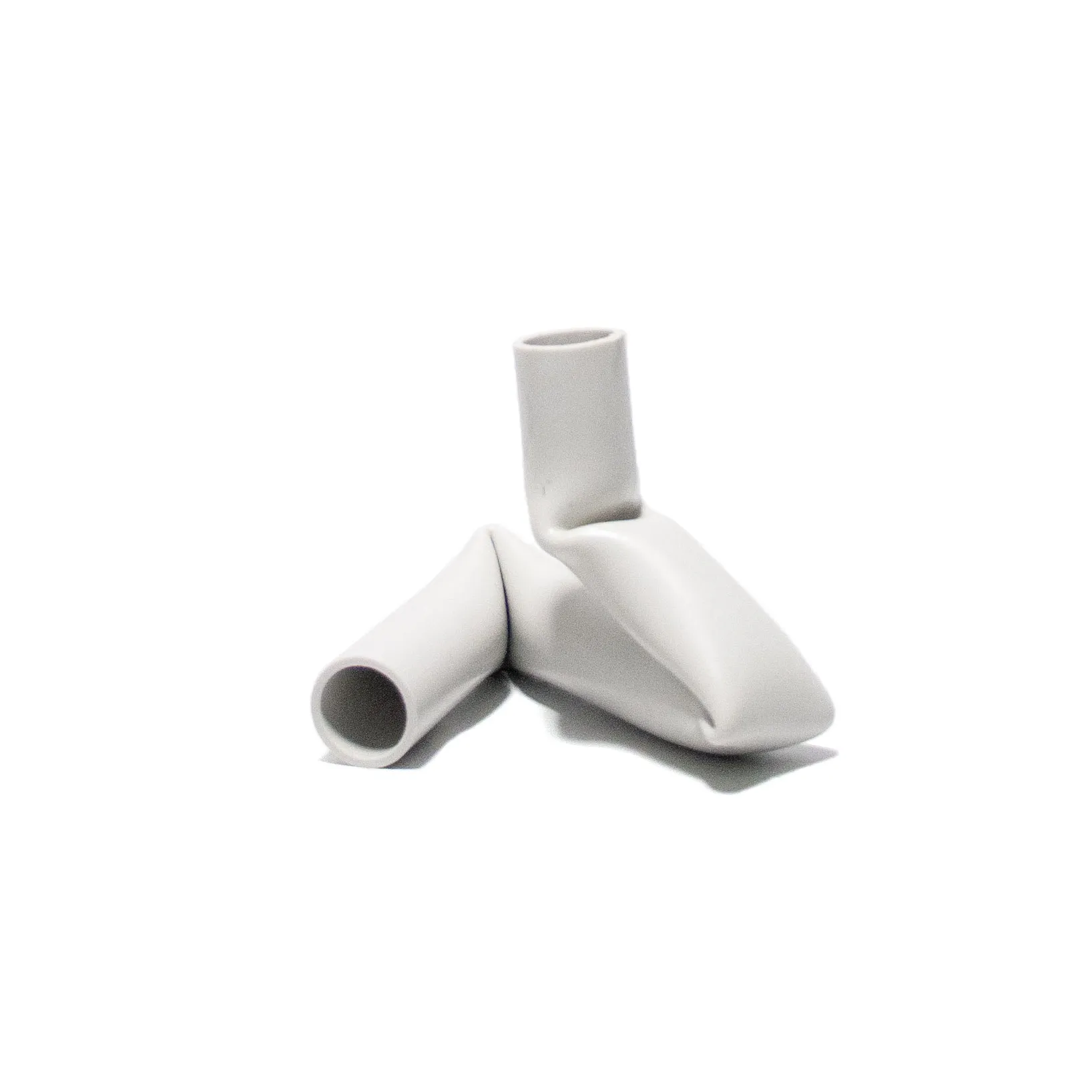 A candle holder created by Jannis Schäfer Studio, made from upcycled PVC tube. The design features a unique, twisted form with two cylindrical openings for candles. This transformed and reclaimed material piece is part of a series of derivative designs.